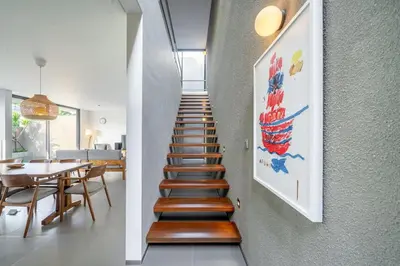 a staircase leading to a living room and a dining room at Casa Nadi in Seminyak