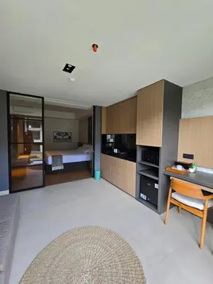 a living room with a couch and a bed at de' Asasta Apartment Benoa N-511 in Nusa Dua