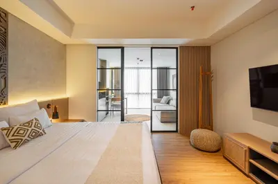 a hotel room with a bed and a television at de' Asasta Apartment Benoa N-511 in Nusa Dua