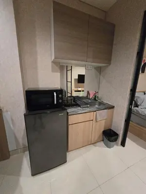 a small kitchen with a sink and a microwave at de Asasta Apartment Benoa E-105 in Nusa Dua