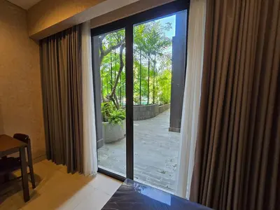a sliding glass door with a view of a patio at de Asasta Apartment Benoa E-105 in Nusa Dua