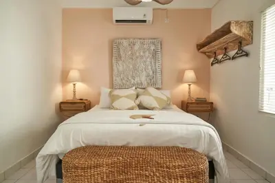 a bedroom with a bed and two night stands at Motel Molly Boutique Rooms Seminyak in Seminyak