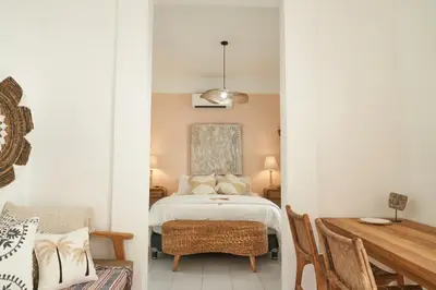 a bedroom with a bed and a table and chairs at Motel Molly Boutique Rooms Seminyak in Seminyak