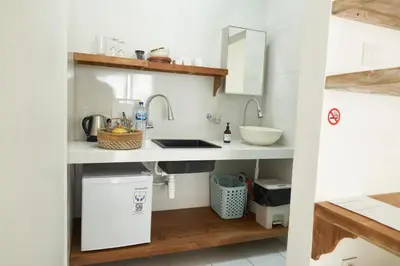 a kitchen with a sink and two faucets at Motel Molly Boutique Rooms Seminyak in Seminyak