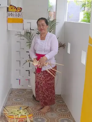 a woman standing next to a toilet in a room at Motel Molly Boutique Rooms Seminyak in Seminyak