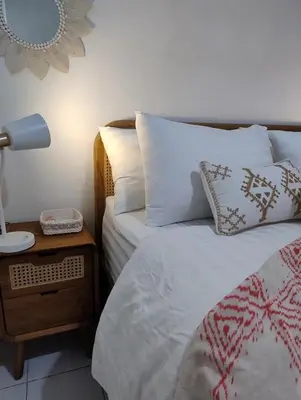 a bedroom with two beds and a lamp on a night stand at Motel Molly Boutique Rooms Seminyak in Seminyak