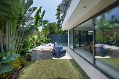 a garden with a table and chairs in a house at Villa Cora Seminyak Walk to Double Six Beach in Seminyak