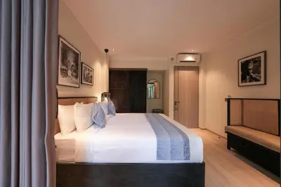 a bedroom with a large bed with white sheets at Villa Cora Seminyak Walk to Double Six Beach in Seminyak