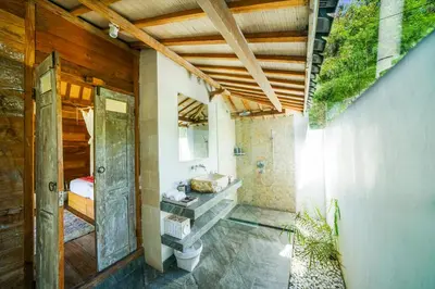 a bathroom with a toilet and a sink at Abaca Villas in Seminyak