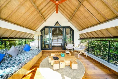 a living room with a couch and a table at Abaca Villas in Seminyak