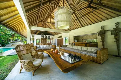 a living room with a couch and a table at Abaca Villas in Seminyak
