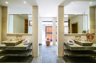 a bathroom with two sinks and a large mirror at Abaca Villas in Seminyak