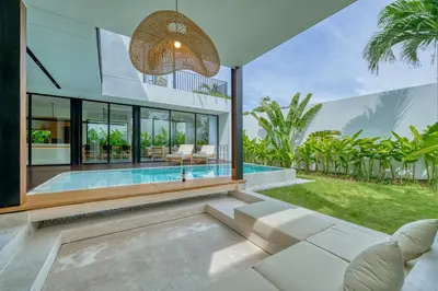 an exterior view of a house with a swimming pool at Luxury Industrial-Style 2BR Villa Kirma Near the Beach in Canggu