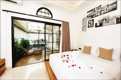 a bedroom with a bed and a large window at Danbi Villa Bali By Bali Cabin in Canggu