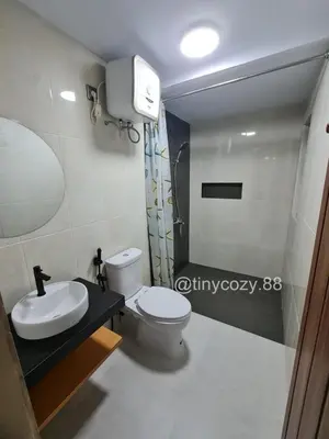 a bathroom with a toilet and a sink at Home88 Sanur in Sanur