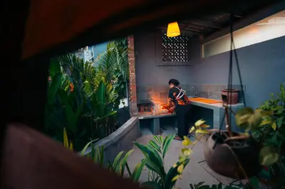 a person standing in a kitchen preparing food at Bali Akasa Villa in Seminyak