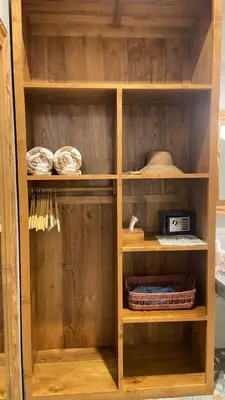 a wooden book shelf with a radio in it at Santai Suites Nusa Dua-Child Free in Nusa Dua