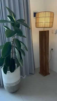 a potted plant in a room next to a lamp at Santai Suites Nusa Dua-Child Free in Nusa Dua