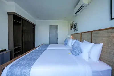 a bedroom with a large bed with white pillows at Twin Villas Drupadi 8BR Seminyak by Exotic Bali Properties in Seminyak
