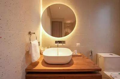 a bathroom with a white sink and a mirror at Twin Villas Drupadi 8BR Seminyak by Exotic Bali Properties in Seminyak
