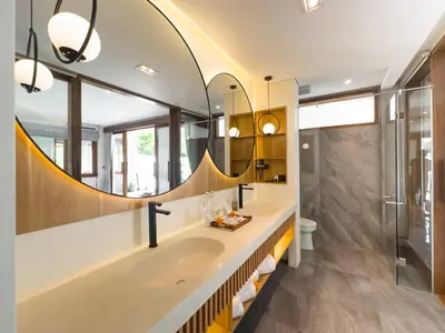 a bathroom with two sinks and a large mirror at The Aurum Canggu Villas by Nagisa Bali in Canggu