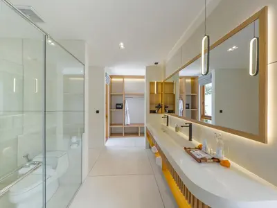 a bathroom with a large mirror and a sink at The Aurum Canggu Villas by Nagisa Bali in Canggu