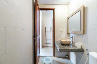 a bathroom with a bowl sink and a mirror at Villa Azure 3 - Tropical 4-Bedroom Pool Villa Near Seminyak in Seminyak