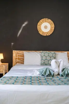a bedroom with a white bed with a black wall at Villa Azure 3 - Tropical 4-Bedroom Pool Villa Near Seminyak in Seminyak