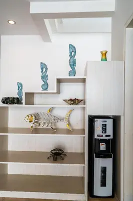 a shelf with a fish figurine next to a coffee maker at Villa Azure 2 - Master Suite in shared Pool Villa in Seminyak