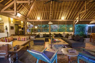 a living room with a couch and a table at Villa Damai Manis in Seminyak