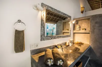 a bathroom with a sink and a mirror at Villa Damai Manis in Seminyak