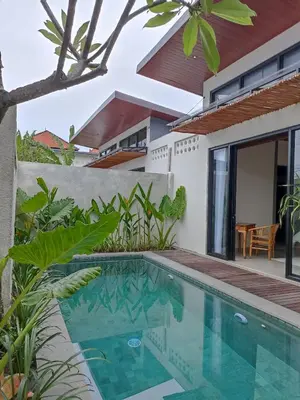 a villa with a swimming pool and a house at Villa Juanjo Sanur in Sanur