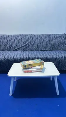 two books sitting on a table next to a bed at Santorini House in Bali Near Airport in Kuta