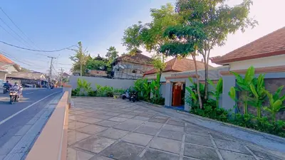 a street in a town with houses and trees at Deva Guest House - Kerobokan in Seminyak