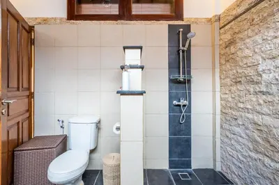 a bathroom with a toilet and a shower at Tropical Villas - 2 Bed & 3 Bed in Kerobokan