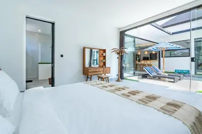 a bedroom with a large bed and a balcony at 3Br New Private Family Villa- Sanur in Sanur