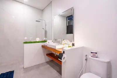 a white bathroom with a sink and a toilet at 3Br New Private Family Villa- Sanur in Sanur