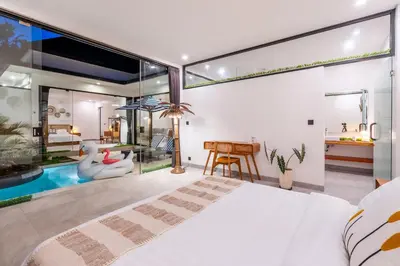 a bedroom with a large bed and a living room at 3Br New Private Family Villa- Sanur in Sanur