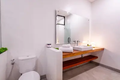 a bathroom with a white toilet and a sink at 3Br New Private Family Villa- Sanur in Sanur