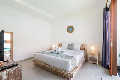 a bedroom with a bed and a clock on the wall at Villa Azure 3 - Private Suite in Shared Tropical Pool Villa in Seminyak