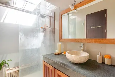 a bathroom with a bowl sink and a mirror at Villa Stephana Edge of Seminyak in Canggu