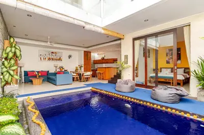 a house with a swimming pool and a living room at Villa Stephana Edge of Seminyak in Canggu