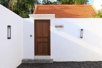 a white building with a door and a sign on it at Gorgeous 1 Bed Pool Villa, Walk to Beach, Shops in Seminyak