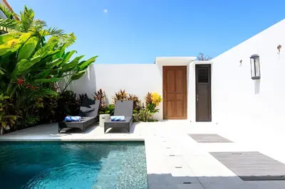 a pool in front of a house with chairs and a door at Gorgeous 1 Bed Pool Villa, Walk to Beach, Shops in Seminyak