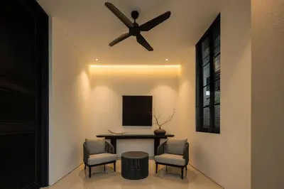a dining room with a ceiling fan and a table and chairs at Marvee Villa Bali in Canggu