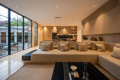 a large bed in a living room with windows at Marvee Villa Bali in Canggu