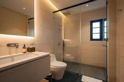 a bathroom with a toilet and a sink and a shower at Marvee Villa Bali in Canggu