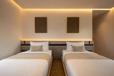 two beds sitting next to each other in a room at Marvee Villa Bali in Canggu