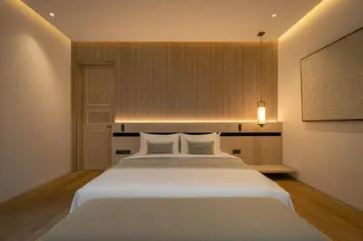 a bedroom with a large white bed with two pillows at Marvee Villa Bali in Canggu