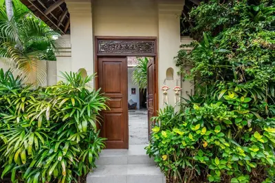 an entrance to a house with a wooden door at Just a 3 min stroll to the Seminyak beach in Badung